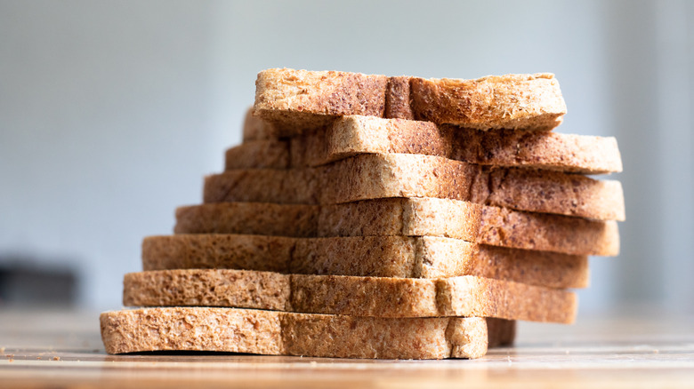A stack of sliced, whole wheat bread