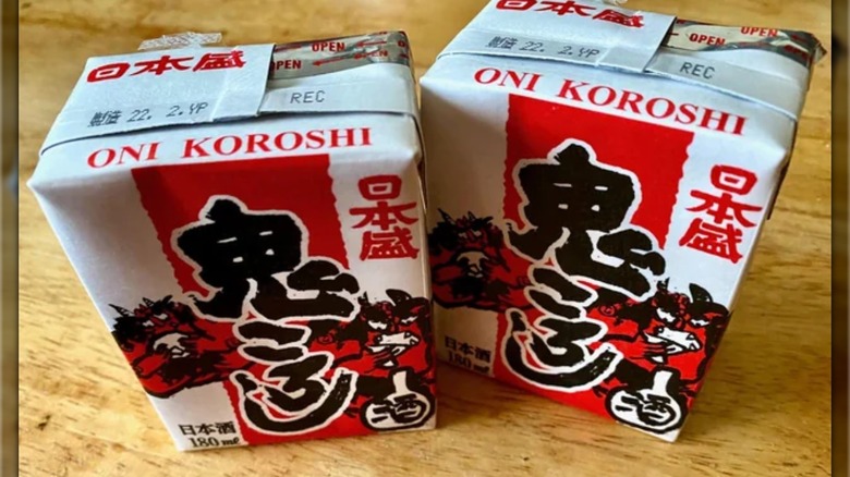 Two small, red and white boxes of Nihonsakari Oni Koroshi Sake