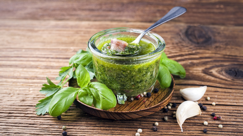 Italian-style salsa verde in a bowl surrounded by some of its main ingredients.