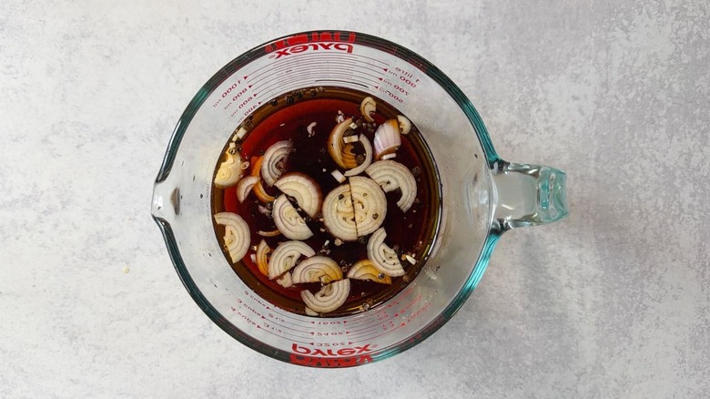Sambal matah-ish grilled pork chop brine in glass measuring cup