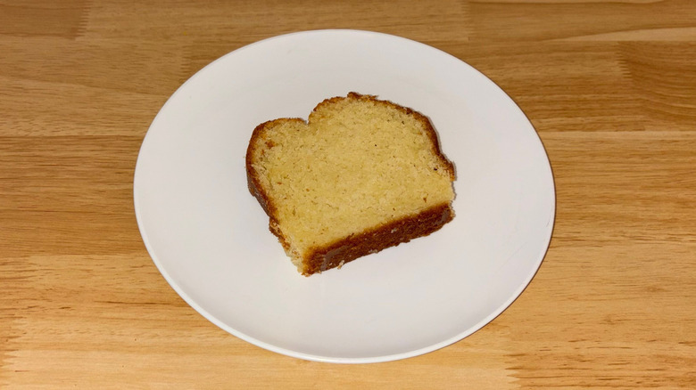 A piece of vanilla pound cake on a white plate.