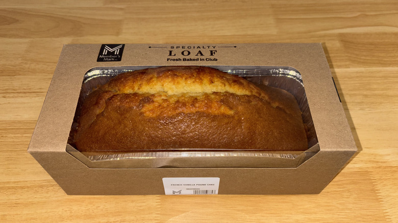 A loaf of vanilla pound cake in a cardboard box with a clear plastic top.