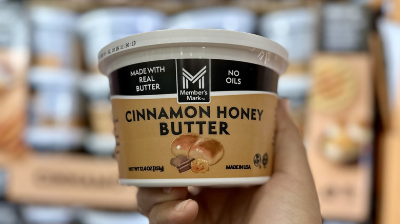 Person holding a container of Member's Mark Cinnamon Honey Butter