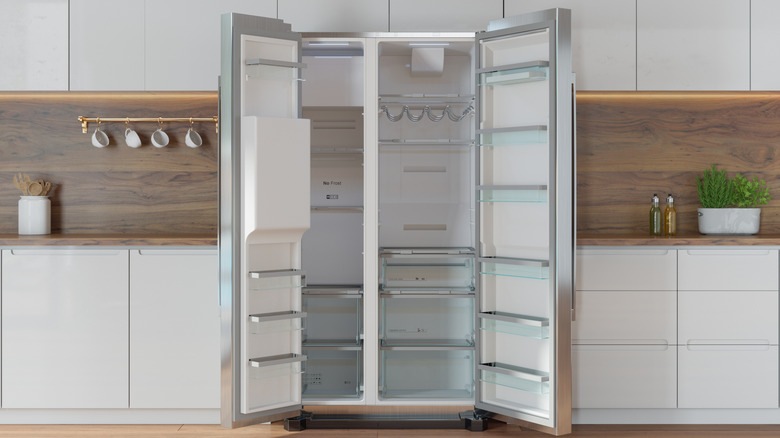 New empty refrigerator with both doors open in a modern kitchen
