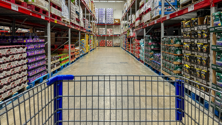A shopping cart in an empty aisle at Sam's Club