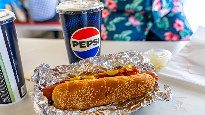 food court hot dog and soda in a pepsi cup
