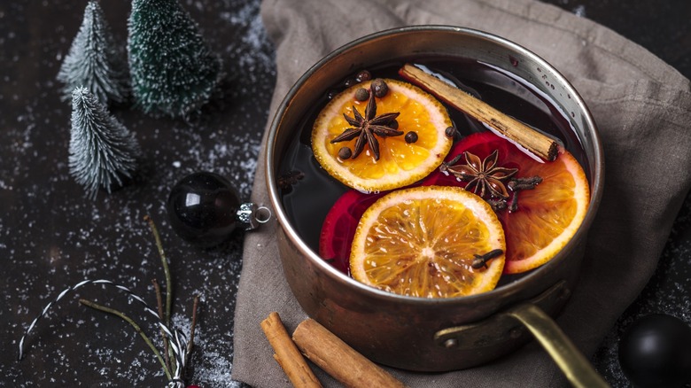 Pot of mulled wine with sliced oranges and star anise
