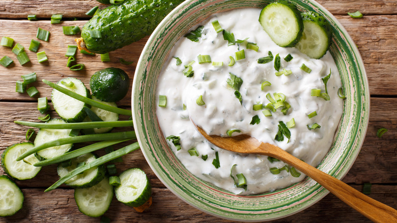Bowl of raita and sliced cucumbers