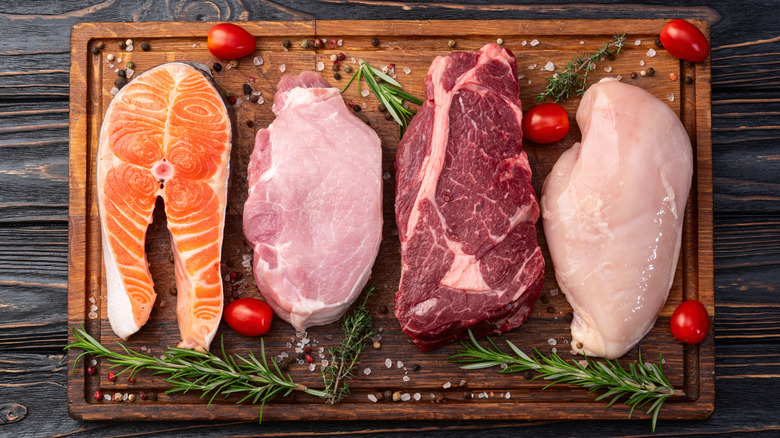 An arrangement of different meat on a wooden board