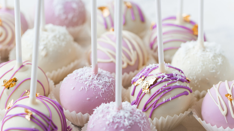 assortment of violet cake pops in paper wrappers
