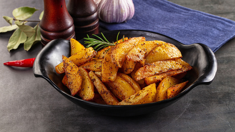 A dish of golden potato wedges.