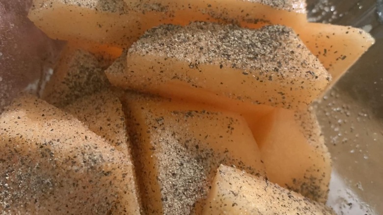 Close-up photo of cantaloupe seasoned with salt and pepper