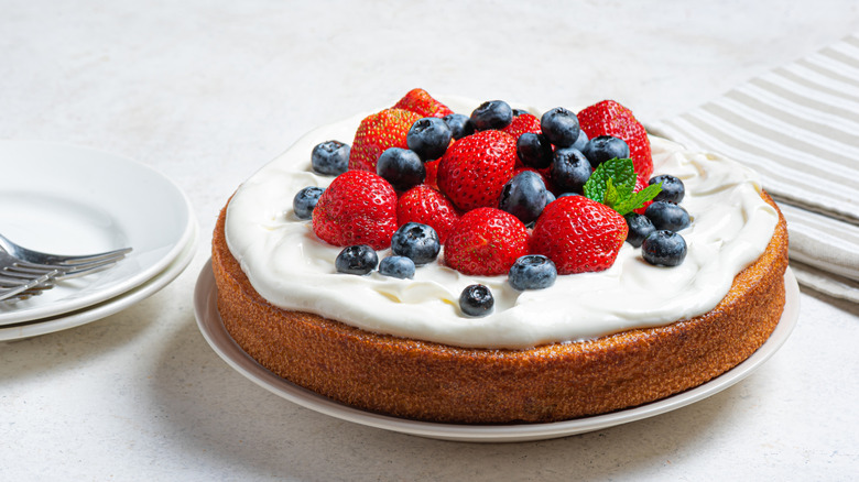 a sponge cake covered in fresh berries