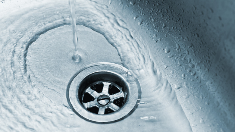 kitchen drain with water pouring down