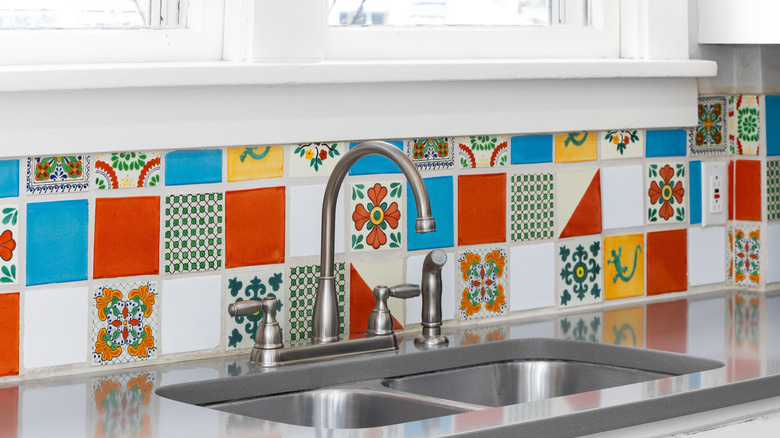 Colorful kitchen tile backsplash behind a kitchen sink