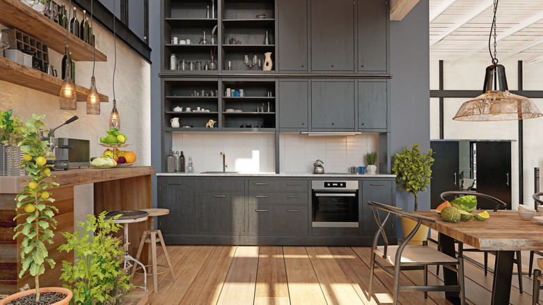 A cozy kitchen with wooden accents, potted plants and mismatched stools that add character