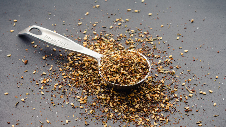 A spice blend is styled to spill out of a tablespoon.