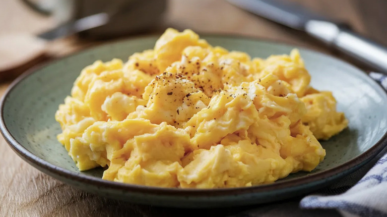 A plate of fluffy, yellow scrambled eggs.