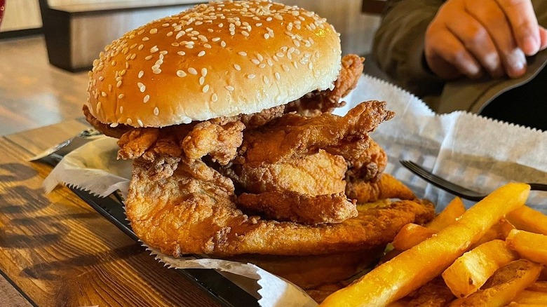 A fish sandwich from the Skrimp Shack restaurant served alongside french fries