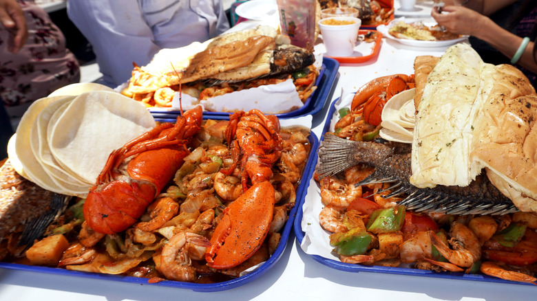 Various seafood trays on a table at San Pedro Fish Market.