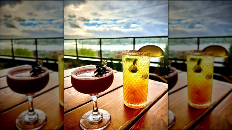 Cocktails at Little Water Cantina in Seattle with Lake Union behind them.