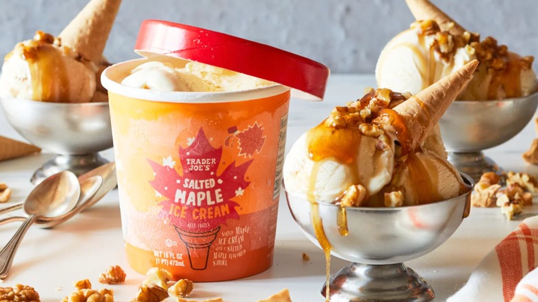 a carton of TJ's salted maple ice cream with cones behind it