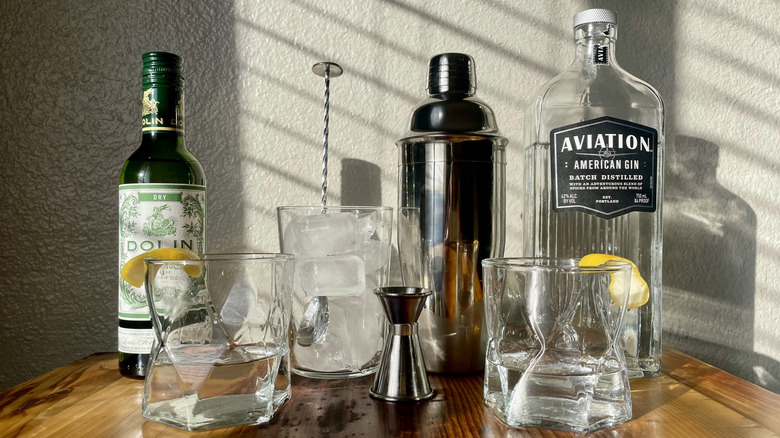 Two classic gin martinis with the supplies used to make them.