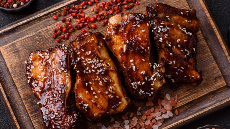 Pork ribs on a wooden tray with a luscious glaze