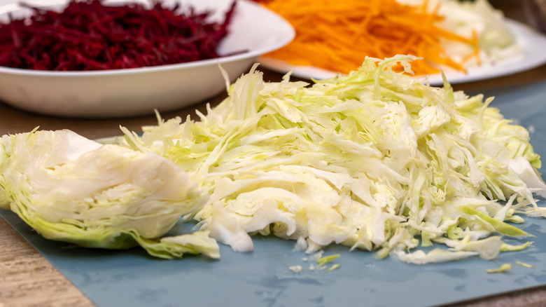 Shredded cabbage on a plastic chopping board