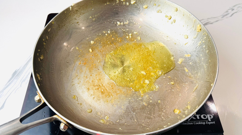 Oil and minced garlic in pan