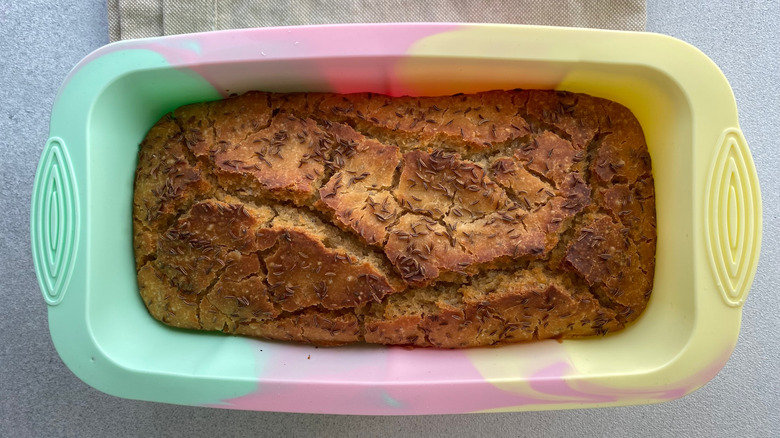 Freshly baked sourdough bread in a colorful silicone mold