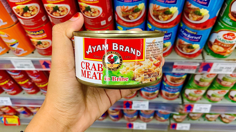 close up of canned crab meat with white background