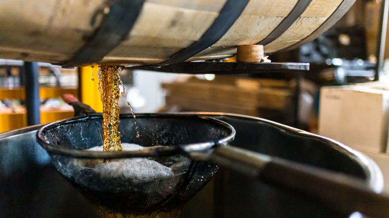 Whiskey coming out of cask