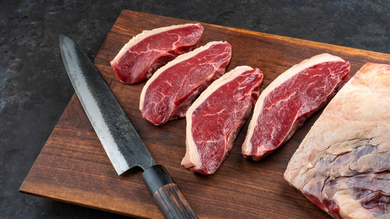 Sliced picanha steaks on a cutting board.