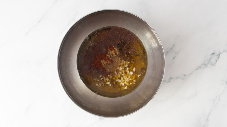 Carne asada marinade ingredients in a medium metal bowl.
