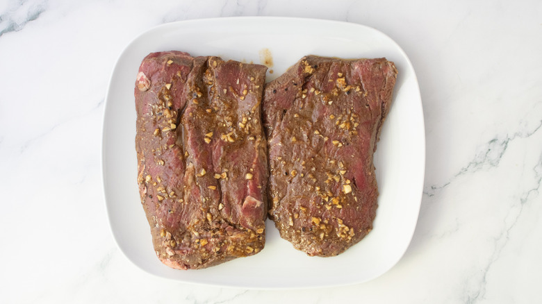Well marinated steak on a large white plate