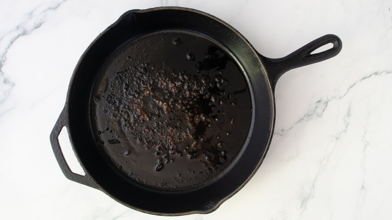 Olive oil drizzled in a large cast iron skillet