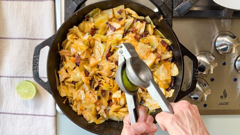 Adding fresh lime juice to skillet cowboy cabbage