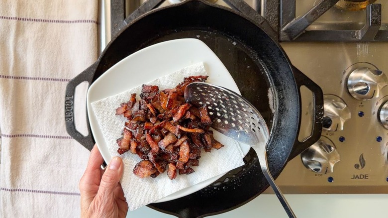 Crispy bacon lardons on paper towel-lined plate