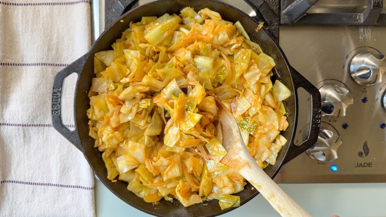 Stirring skillet cowboy cabbage on stovetop