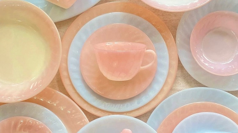 Fire-King plates and cups are laid out on a table