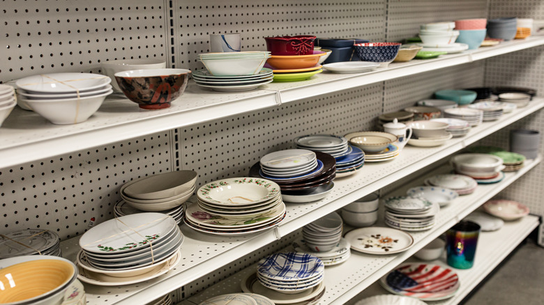 Thrift store shelves filled with a variety of dishes