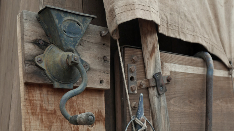 A manual coffee grinder on an old west chuck wagon, where cooks would prepare food and beverages for cowboys.