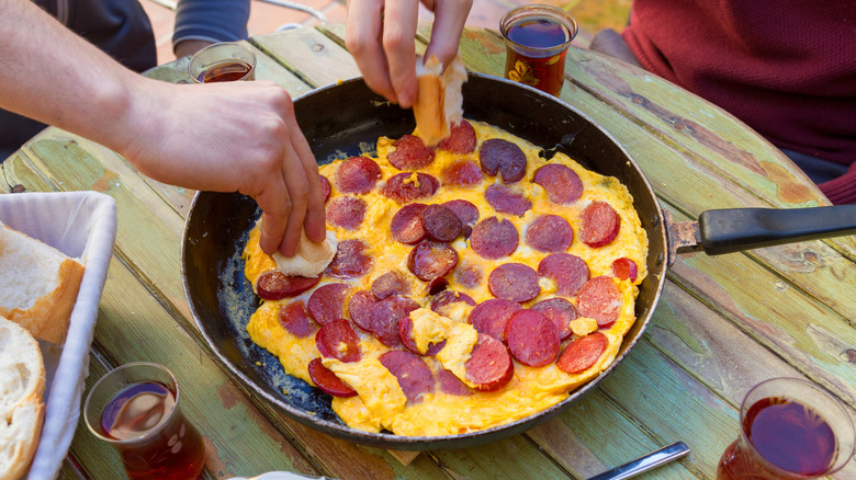 A pepperoni omelet in a frying pan.
