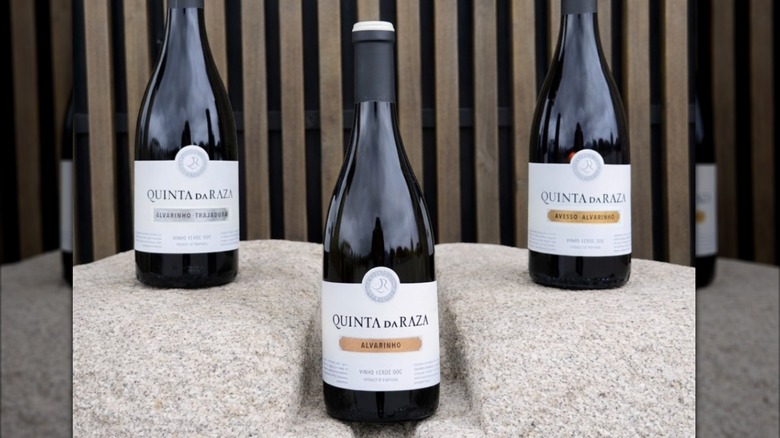 Three bottles of Quinta Da Raza wine on a stone