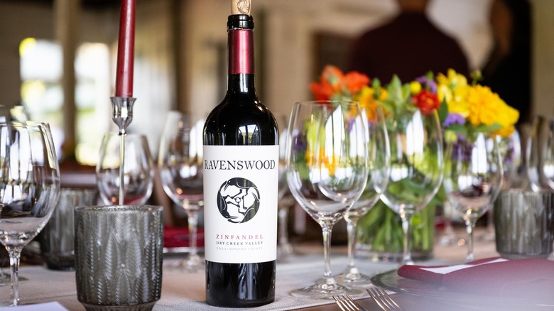 A bottle of Ravenswood Zinfandel on a table with glasses