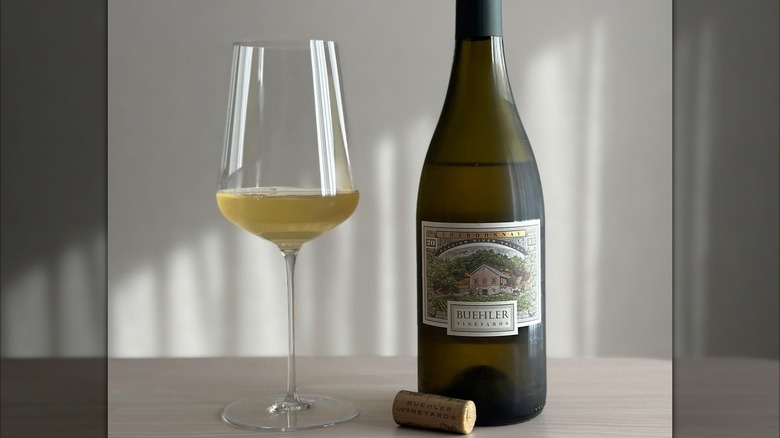 A bottle and glass of Buehler Vineyards Chardonnay on a table