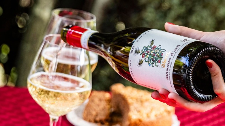 A person pouring a glass of Vietti Moscato d'Asti