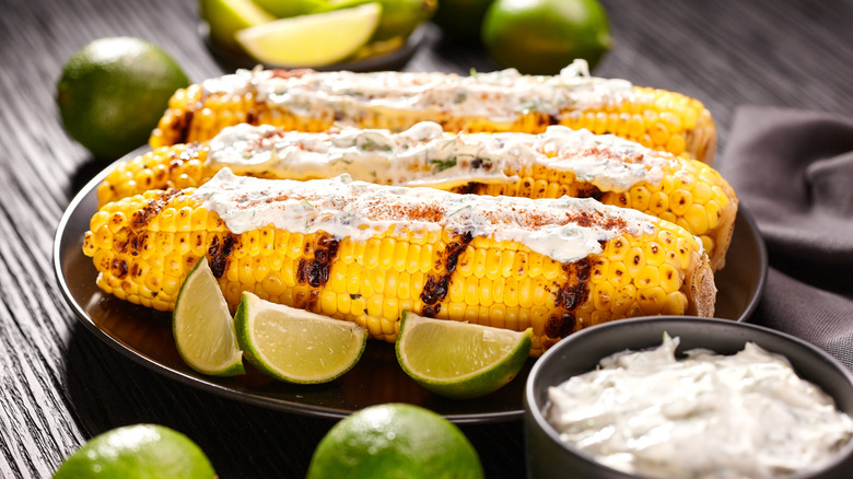 Grilled corn on the cobb with cream cheese and lime