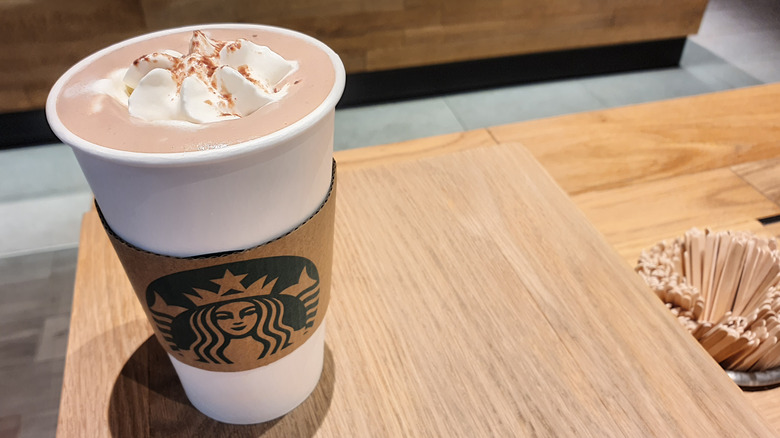 A cup of Starbucks' Signature Hot Chocolate with a hot sleeve
